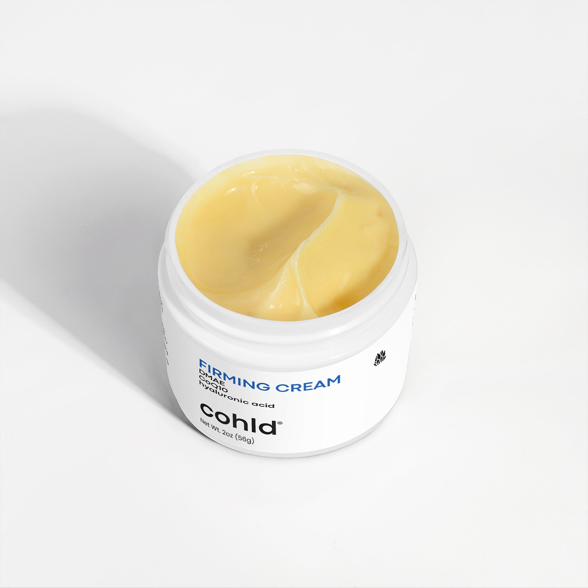 Cohld Skin Firming Cream open jar showing rich natural cream texture – made with DMAE, Hyaluronic Acid and CoQ10